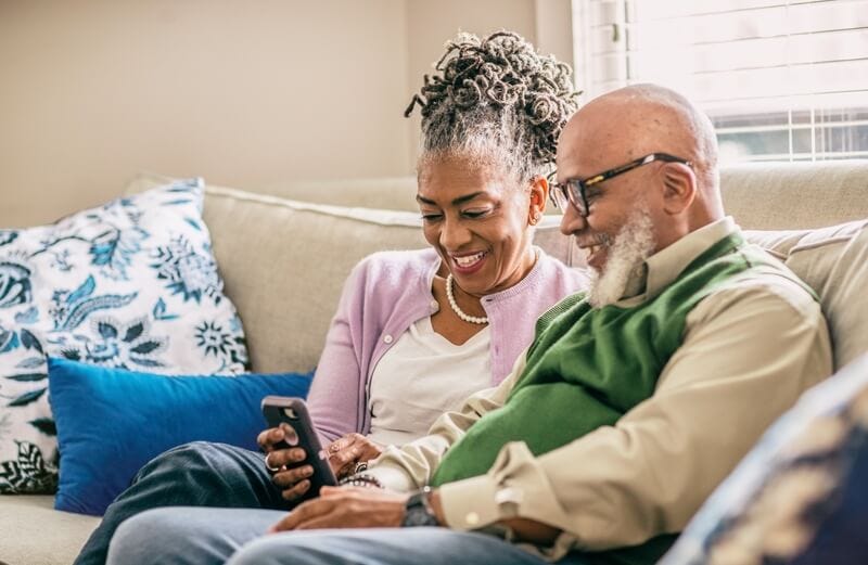 Picture of two people going through a phone