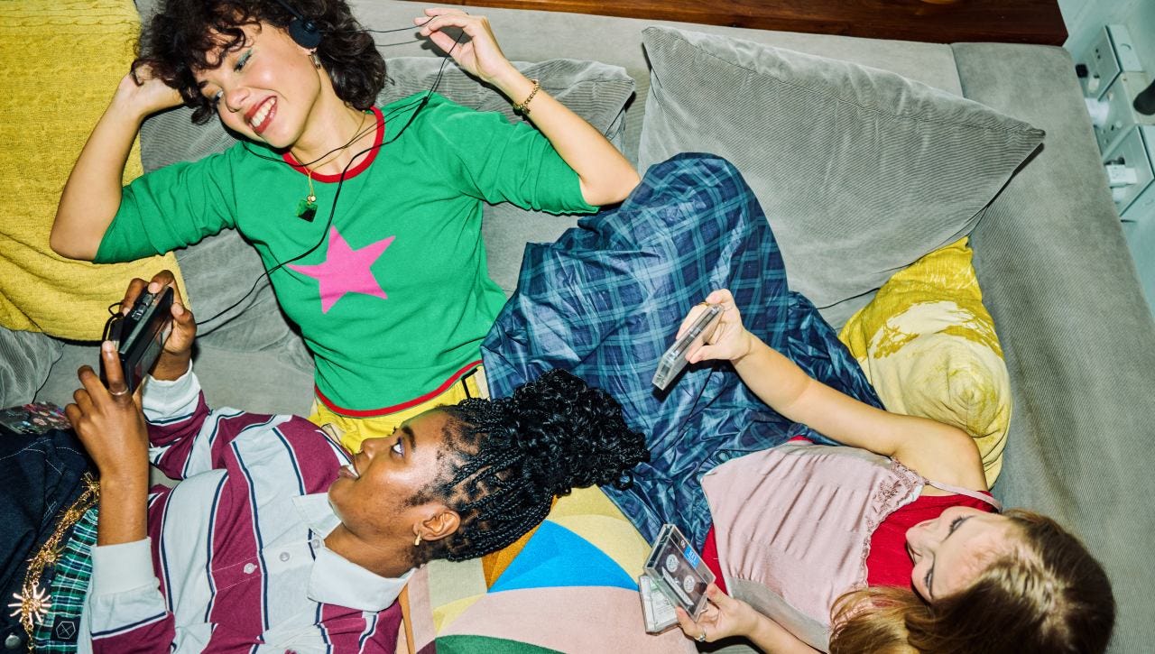 Group of friends listening to music on the sofa