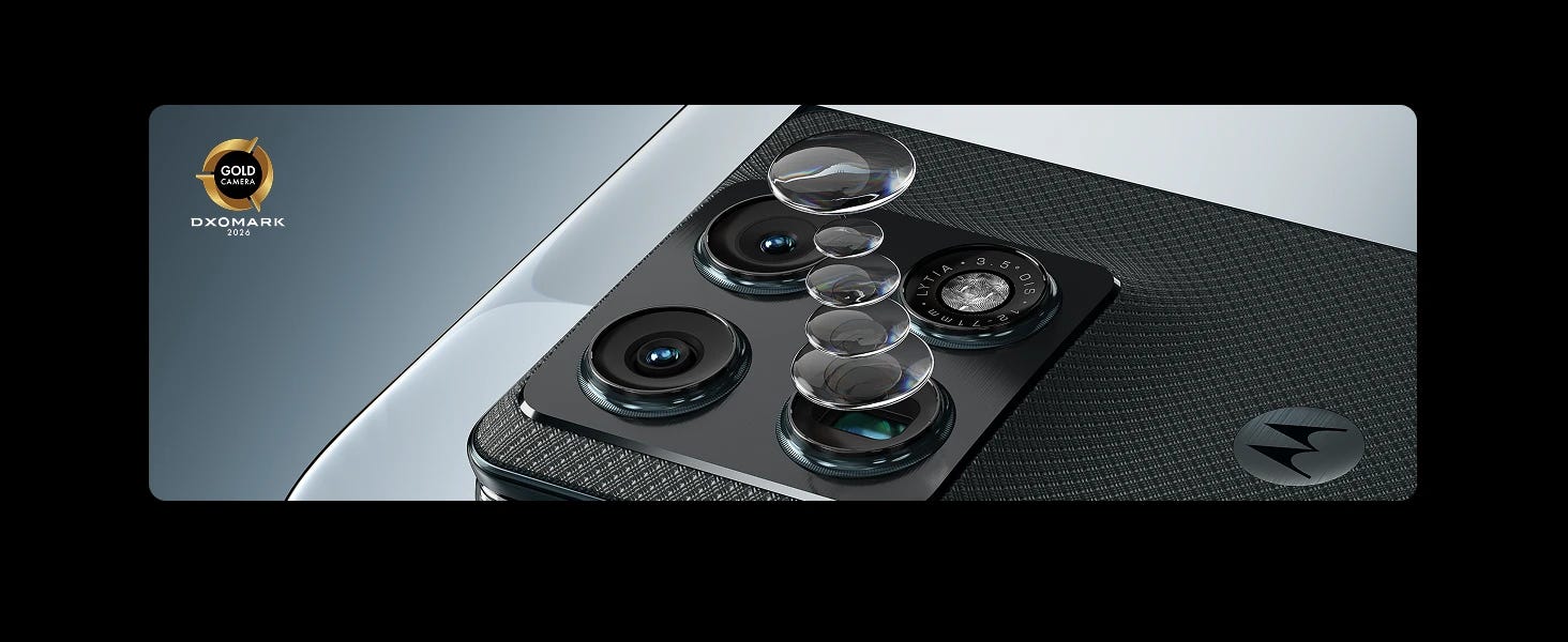 Close-up of a Motorola smartphone's rear cameras with four lenses and lens elements shown. A DXOMARK Gold Camera 2024 award emblem appears on the side.