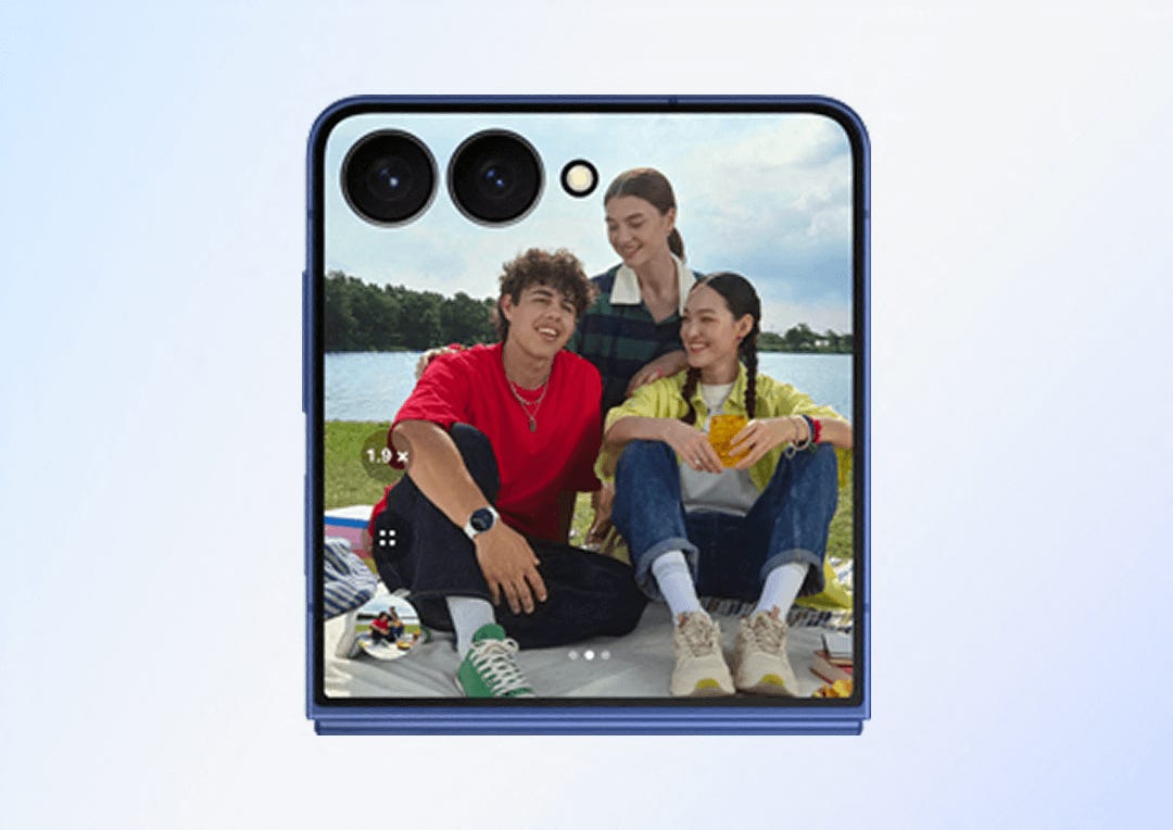 A group of 3 friends having a picnic and taking a selfie